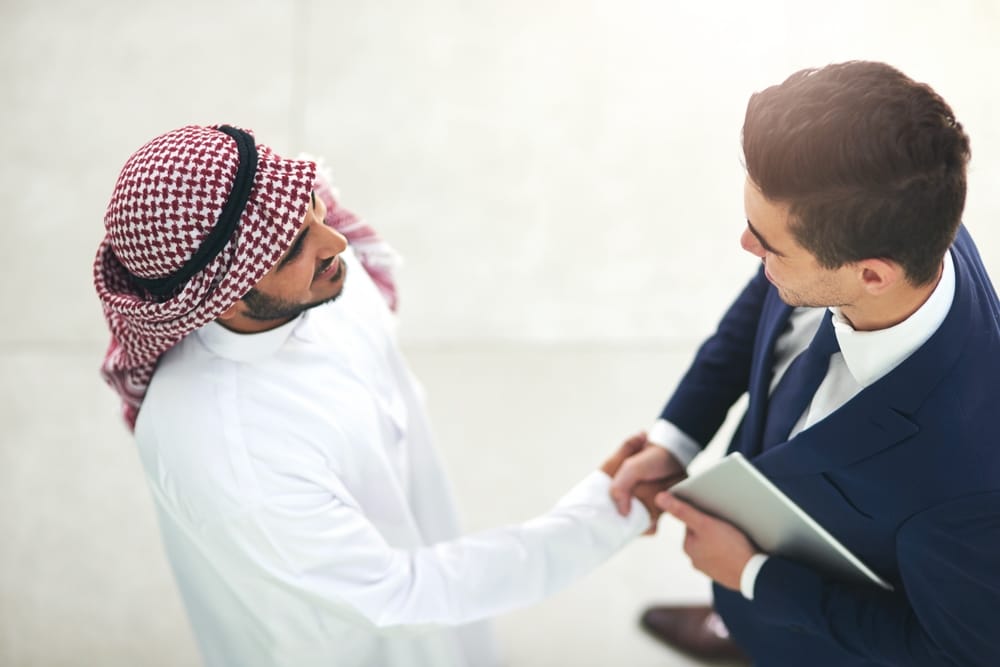 Recruiter and client handshake in Middle East